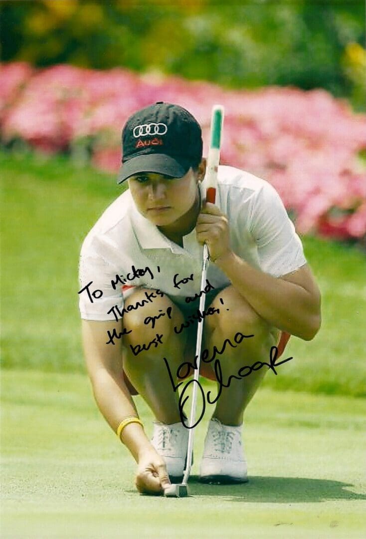 A man holding onto the golf club while kneeling down.