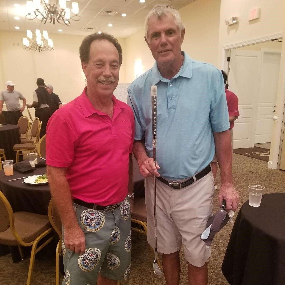 Two men posing for a picture at an event.