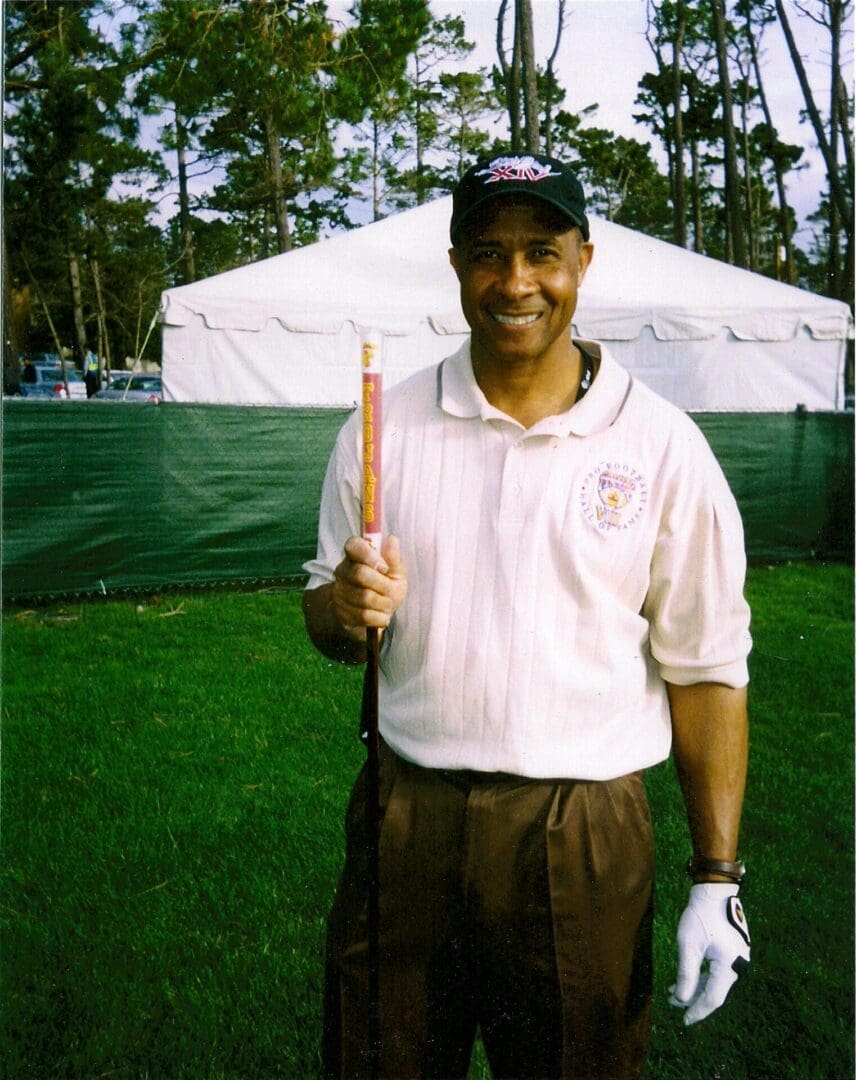 A man holding a golf club in his hand.