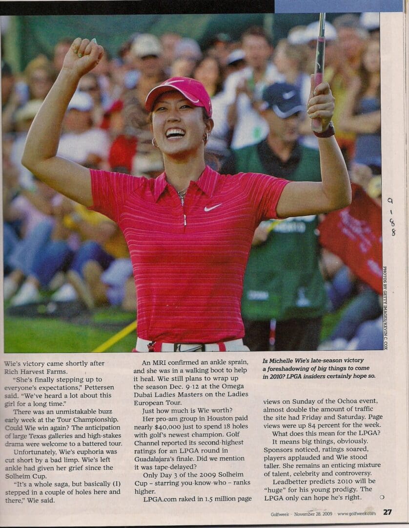 A woman in red shirt holding up her arms.