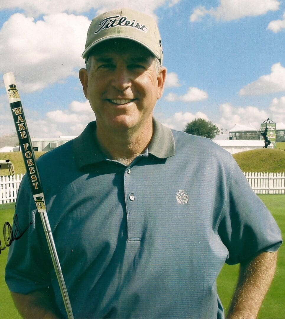 A man holding a golf club in his hand.